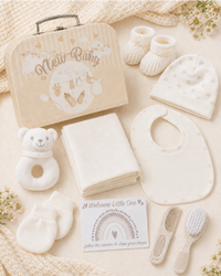 Cream - 9CXS21-C - Contents laid out flat: cotton bib, hat, mittens, bootees, muslin, rattle toy and brush and comb set