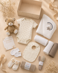 Cream - 9TR40-C - Contents of the cream hamper laid out flat, including cotton garments, muslins, washcloths, hooded towel, fleece blanket and soft toy