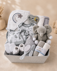 Grey - 9TR40-G - Side angle of the grey presentation tray showing the folded cotton garments, fleece blanket and soft toy arranged inside