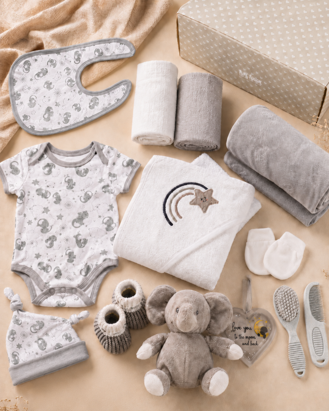 Grey - 9TR40-G - Contents of the grey hamper laid out flat, including cotton garments, muslins, washcloths, hooded towel, fleece blanket and soft toy