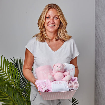 women with pink baby gift hamper